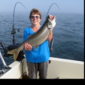 Henderson Harbor Fishing with Milky Way Charters - Hilga showing off one of her Lake Trout