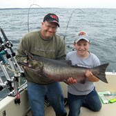 Henderson Harbor Fishing with Milky Way Charters - Neil and Son Derek, Showing Off His King!
