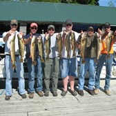 Henderson Harbor Fishing with Milky Way Charters - Ben Pate and buddies holding their trophy walleye catch along with 1 Pike
